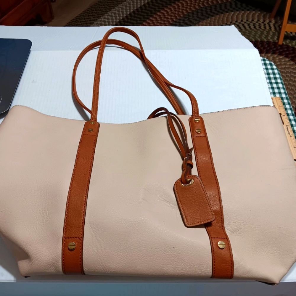 Creamy satchel with brown straps.